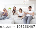 Family with smartphones at home 103168407