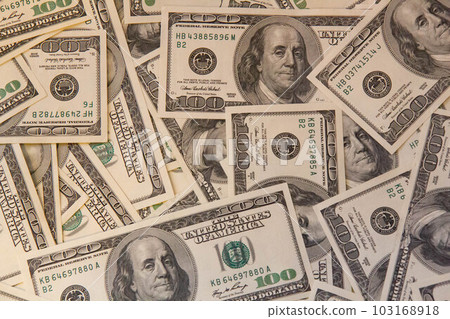 Many hundred dollar bills on the table. One hundred US dollar bills background. U.S. dollars. Banking and finance signs. Much money background. Top view. Close-up 103168918