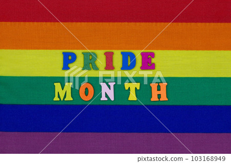 Pride Month letters on the LGBT flag background. Rainbow flag is a symbol of the rights of homosexual, gay, lesbian and transgender people. Concept Expression and diversity of the LGBTQI community 103168949