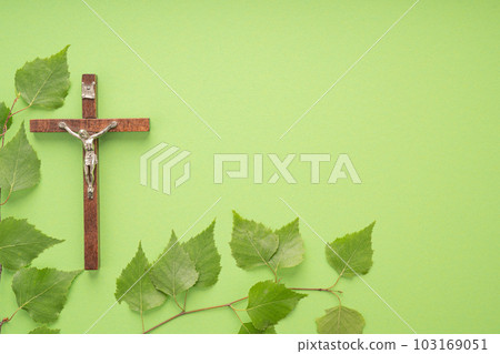 Christian Pentecost. Whit Sunday. A cross with a birch branch on a white, green, red and black background. 103169051