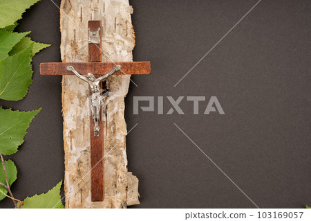Christian Pentecost. Whit Sunday. A cross with a birch branch on a white, green, red and black background. Christian Pentecost. Whit Sunday. A cross with a birch branch on a white, green, red and black background. 103169057