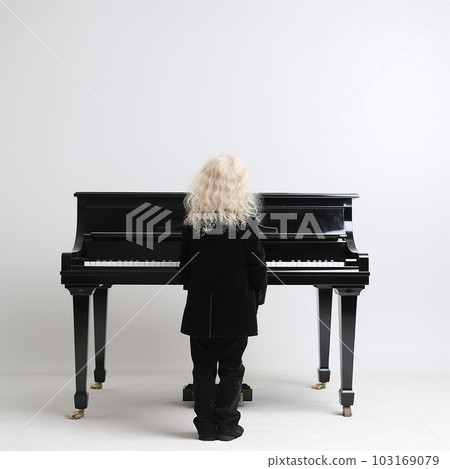Little boy with blond hair in ancient medieval black clothes stay before the harpsichord piano, little Mozart, isolated on white 103169079
