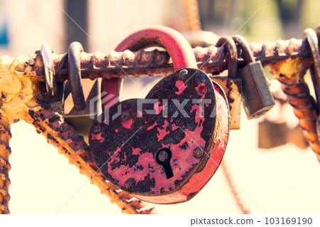Old padlock. Door lock in the form of a heart. Old padlock. Door lock in the form of a heart. 103169190