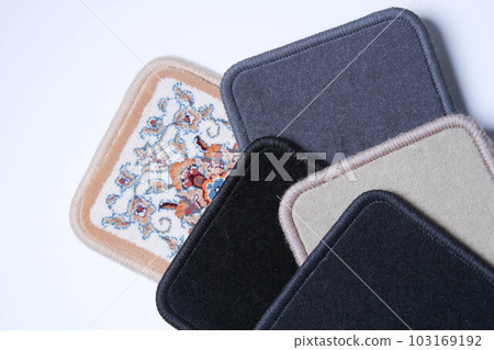 Carpet. Floor covering samples. Multi-colored rug with stitched edges. Carpet. Floor covering samples. Multi-colored rug with stitched edges. 103169192