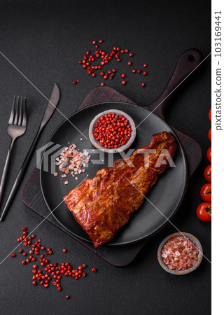 Delicious grilled or smoked pork ribs with salt, spices and herbs Delicious grilled or smoked pork ribs with salt, spices and herbs 103169441