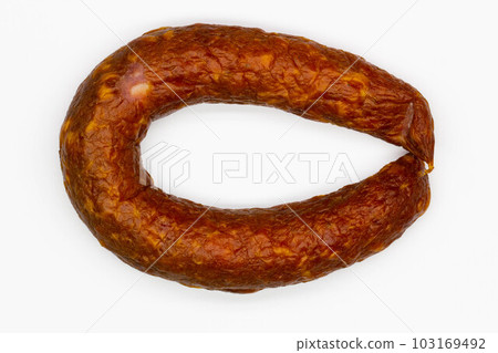 Sausage on a white background. Isolated. Juicy pork sausage with bacon in a beautiful bagel. Fresh homemade beef sausage. Delicious meatloaf with spices. Eco Food. Lamb product. Close-up. Top view 103169492