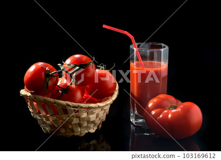 Fresh tomatoes in a basket on a black background 103169612