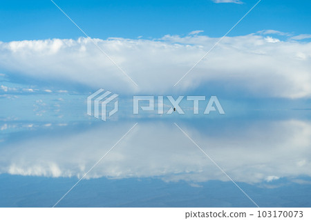 Car at Uyuni Salt Flats. Altiplano, Bolivia. Rainy Season. Tunupa Volcano. Clouds Reflection on 103170073