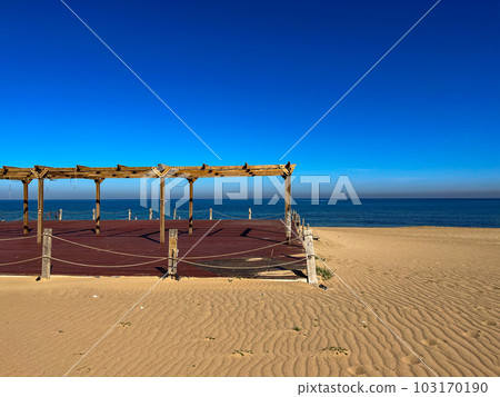 Empty wooden veranda on the sandy beach in Staoueli, Algeria. High quality photo. Clearsea. Blue sky 103170190