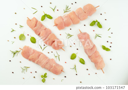 Skewers from raw chicken meat fillet on a white plate for supermarket on white background.Food for retail.Chicken skewers.Chicken breast Fillets.Ogranic food,healthy eating.Raw chicken. 103171547