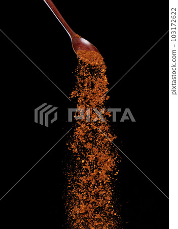 Red Hot Chilli fall, red grain chilli explode abstract cloud fly from wooden spoon. Beautiful complete seed chilly, food object design. Selective focus freeze shot black background isolated Red Hot Chilli fall, red grain chilli explode abstract cloud fly from wooden spoon. Beautiful complete seed chilly, food object design. Selective focus freeze shot black background isolated 103172622