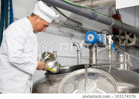 Portrait of brewer who is making beer on his workplace in brew-house Portrait of brewer who is making beer on his workplace in brew-house 103174576