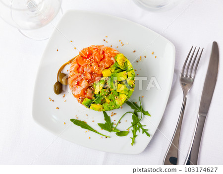 Delicious salmon tartare with avocado, arugula Delicious salmon tartare with avocado, arugula 103174627