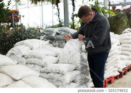 Man looking for natural pebbles at market 103174652