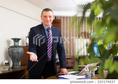 Portrait of man welcoming to company office 103174837