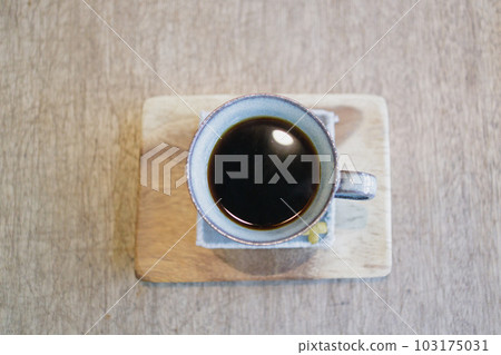 Close-up of coffee and wooden coaster Close-up of coffee and wooden coaster 103175031