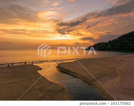 .aerial view stunning reflection of bright golden sky in a canal at Karon beach Phuket. .aerial view stunning reflection of bright golden sky in a canal at Karon beach Phuket. 103175982