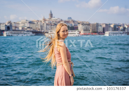 Portrait of beautiful woman tourist with view of Galata tower in Beyoglu, Istanbul, Turkey. Turkiye 103176337