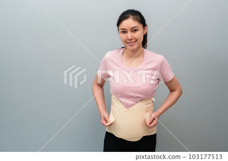 woman wearing lumbar support belts. pregnant and postnatal lumbar brace after surgery woman wearing lumbar support belts. pregnant and postnatal lumbar brace after surgery 103177513