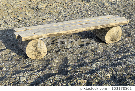 A bench made of a log 103178501