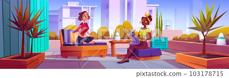 Two women talking on terrace in big city 103178715