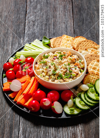 salmon salad with fresh veggies and crackers 103179435