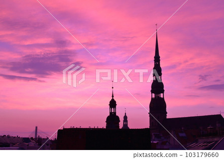 Riga, the capital of Latvia, the northern European Baltic countries, the historic district of Riga, a world cultural heritage site, with the silhouette of the steeple of the church and the sunset sky 103179660