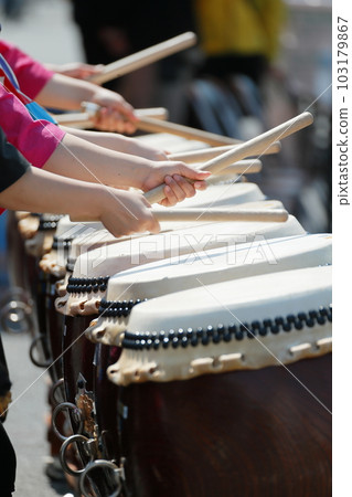 Women playing big drums at a festival Women playing big drums at a festival 103179867