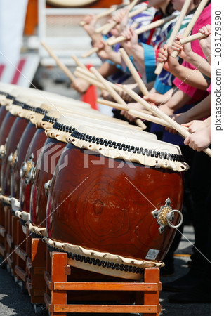 Women playing big drums at a festival Women playing big drums at a festival 103179890