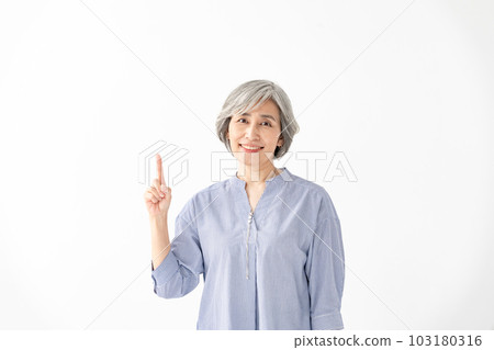 Senior female portrait pointing 103180316