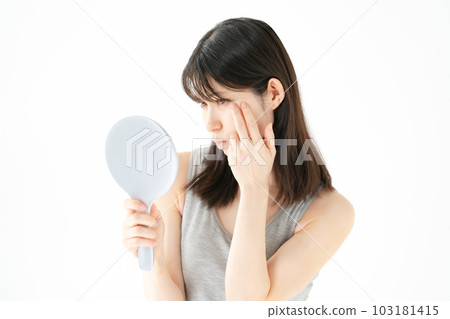Beauty Worried woman looking in the mirror Beauty Worried woman looking in the mirror 103181415