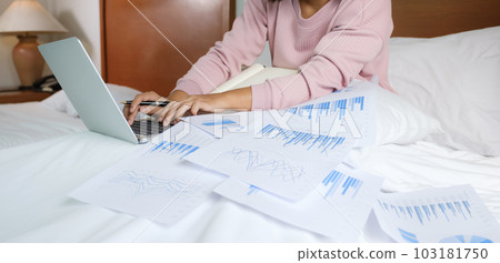 Business women bookkeeper hand use laptop doing account for paying tax on on the bed, work from home concept 103181750