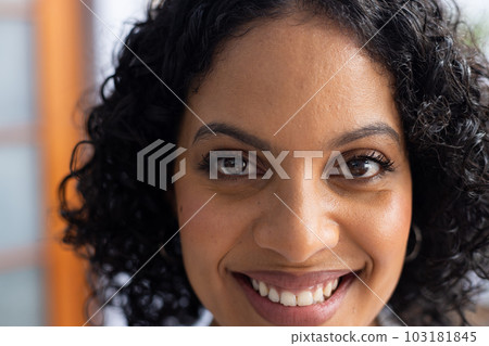 Portrait of happy biracial female doctor looking at camera and smiling 103181845