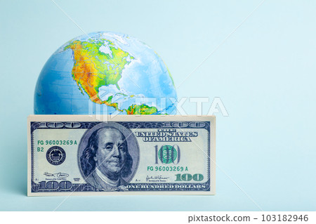 Dollars money on the background of the world globe. Economy, business, crisis concept. Dollars money on the background of the world globe. Economy, business, crisis concept. 103182946