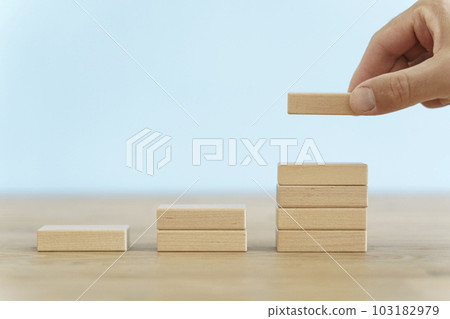 Growth, target, upskill concept. Growth of wooden cubes on a clean background. Business, economics, strategy idea 103182979