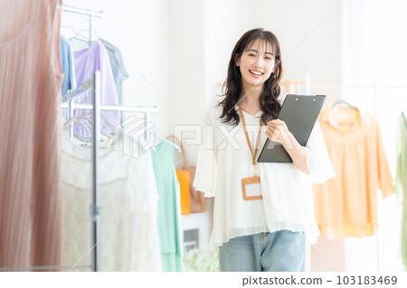 Young female clerk working in an apparel shop Young female clerk working in an apparel shop 103183469