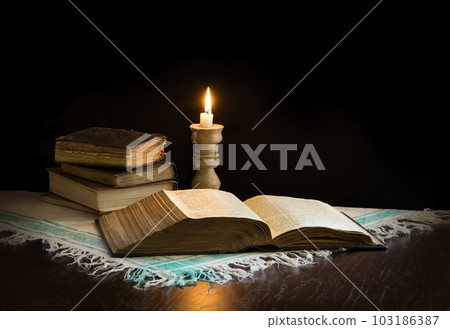 Still life from ancient books with candle 103186387