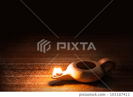 Ancient lamp shines in the dark Ancient lamp shines in the dark 103187411