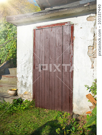 Old wooden door to a vintage dwelling Old wooden door to a vintage dwelling 103187440