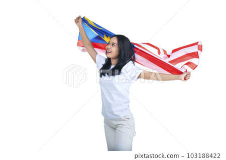 Asian women celebrate Malaysia independence day on 31 August by holding the Malaysia flag 103188422