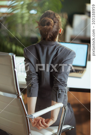 modern business woman in modern green office stretching hand modern business woman in modern green office stretching hand 103188959
