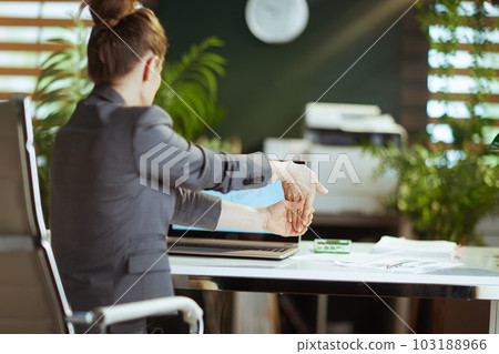 modern business woman in modern green office stretching hand modern business woman in modern green office stretching hand 103188966