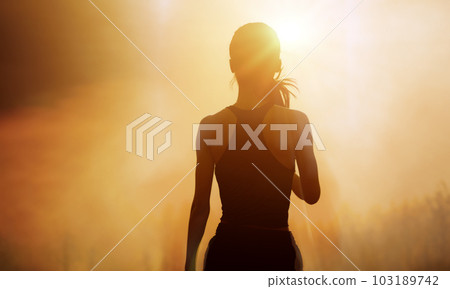Successful, strong woman overcomes difficulties and runs towards her goals and achievements. Female silhouette on sunrise city background. Success Business Leadership. 103189742
