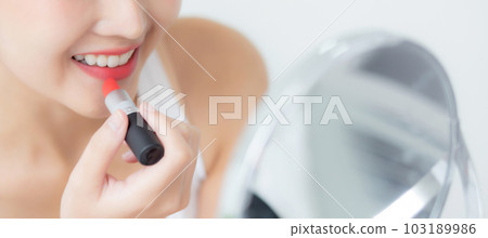 Beautiful young asian woman applying lipstick red on mouth, beauty girl looking facial. Beautiful young asian woman applying lipstick red on mouth, beauty girl looking facial. 103189986