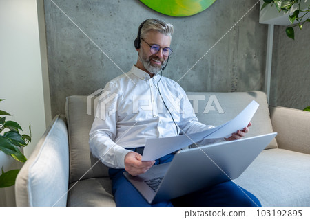 Smiling male entrepreneur dealing with business documents Smiling male entrepreneur dealing with business documents 103192895