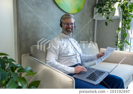 Joyous entrepreneur working in a coworking space Joyous entrepreneur working in a coworking space 103192897