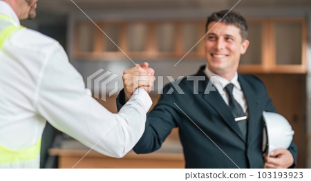 Happy young civil engineer manager and architects handshaking at construction site and looking to next construction phase , cooperation teamwork concept Happy young civil engineer manager and architects handshaking at construction site and looking to next construction phase , cooperation teamwork concept 103193923