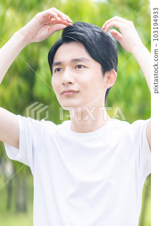 A young man who is worried about his scalp A young man who is worried about his scalp 103194933