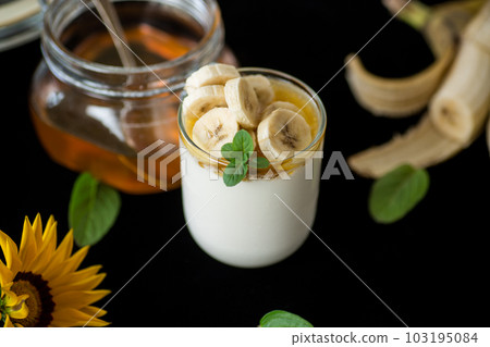 Sweet homemade yogurt with bananas and honey 103195084