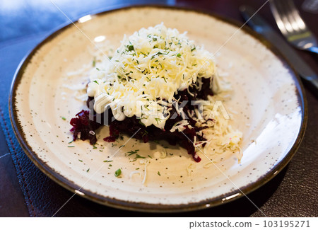 dish of beets, cheese, mayonnaise on a plate in restaurant 103195271